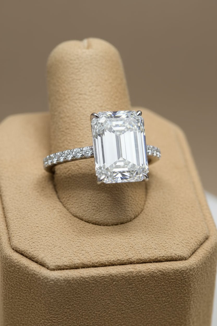 Moissanite ring with emerald cut center stone.