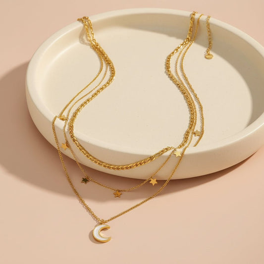 Moonlit goddess layered necklace placed on a white jewelry display plate.