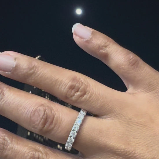Close up of hand wearing Frost Kiss moissanite ring by Golden Noire