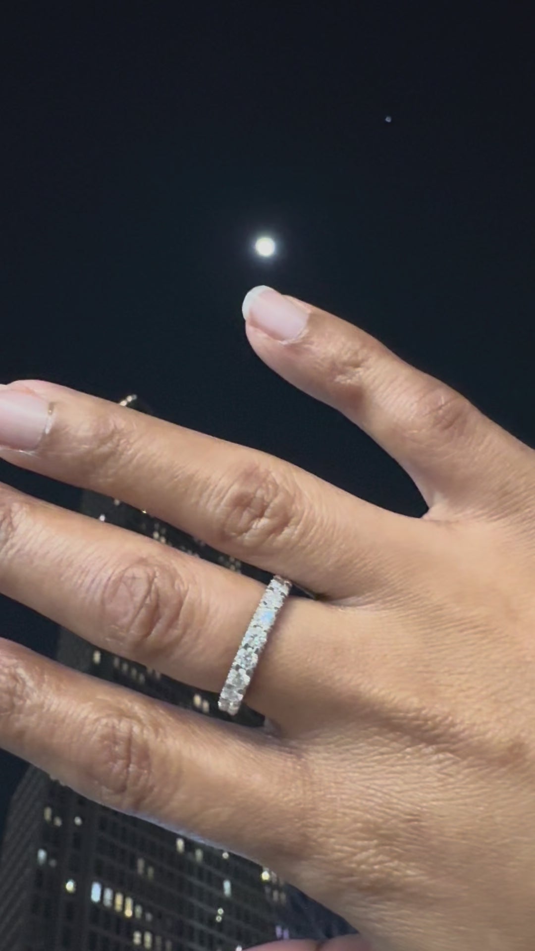 Close up of hand wearing Frost Kiss moissanite ring by Golden Noire